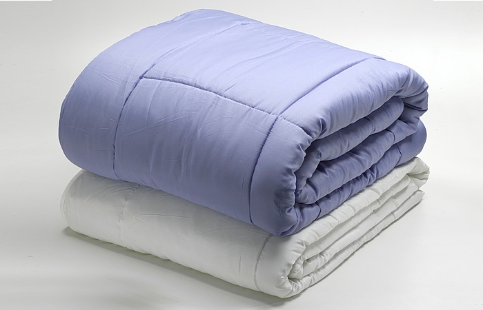 Polyester fibers for comforters and duvets